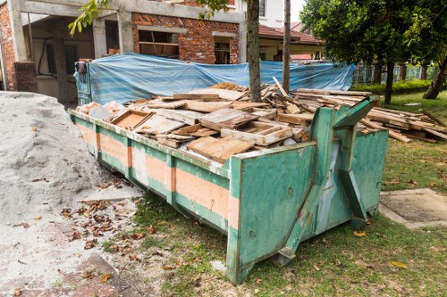 Front view of an Acton office building with clearance workers preparing for removal
