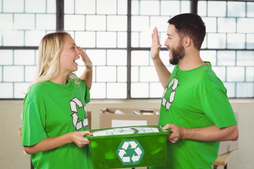 Workers organizing rubbish and recyclable materials during an office removal